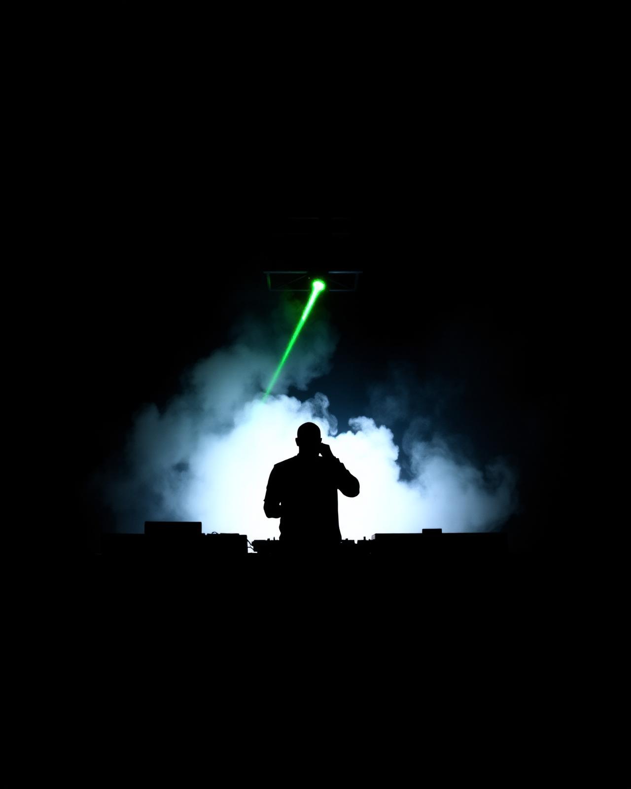 Artist silhouette behind a laser